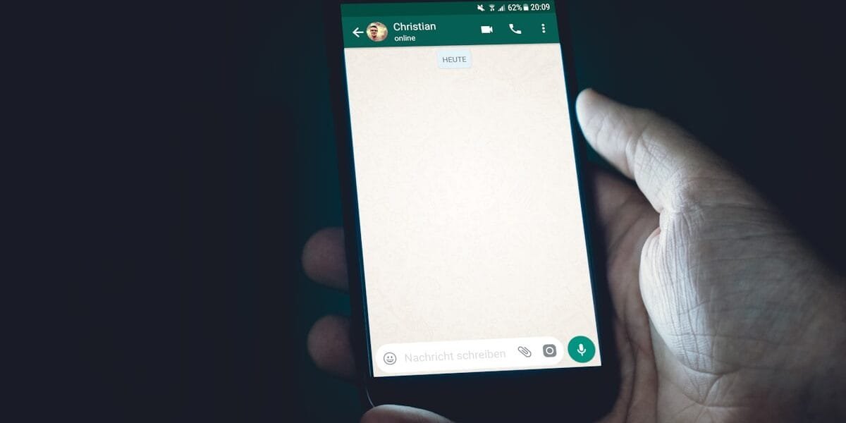 Person holding a smartphone and chatting with ChatGPT, which now shows sponsored ads to free users
