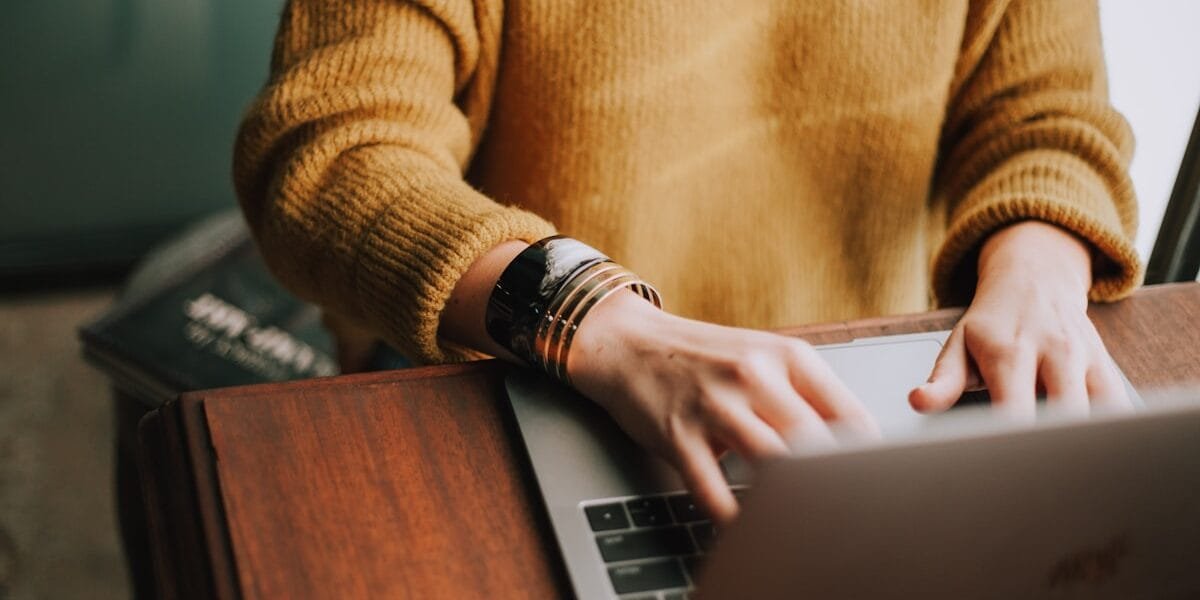 Person typing on a laptop doing gig work, the kind of task Amazon Mechanical Turk used to crowdsource before its 2026 shutdown
