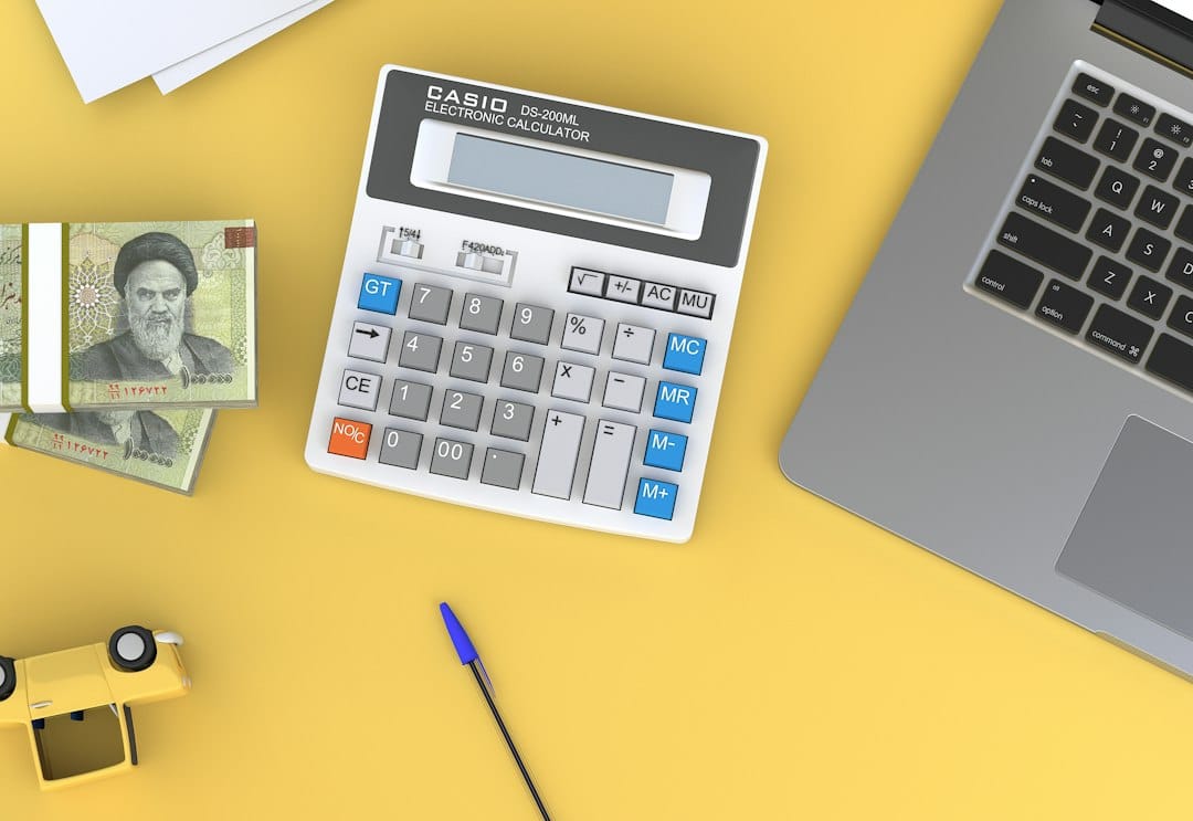 Calculator and laptop on a desk, illustrating whether AI can replace accountants